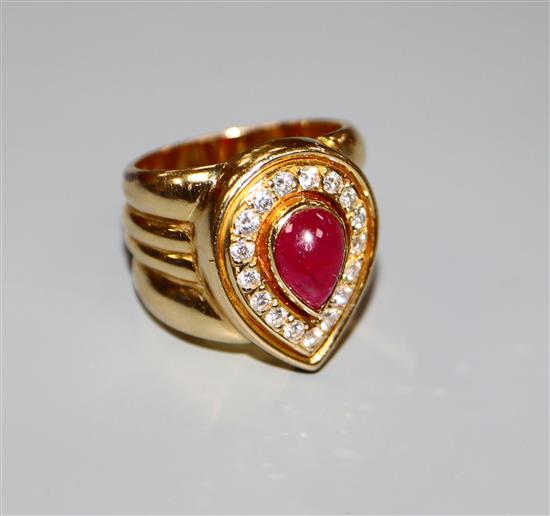 A modern 750 yellow metal, pear shaped cabochon ruby and diamond set dress ring, size N, gross 17.2 grams.